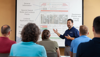A classroom of workers getting trained on lockout tagout software and different aspects of a LOTO procedure.