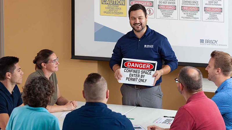 A group of employees receiving an annual refresher training course.