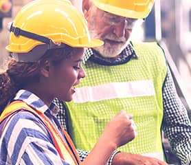 Two manufacturing employees discussing a problem