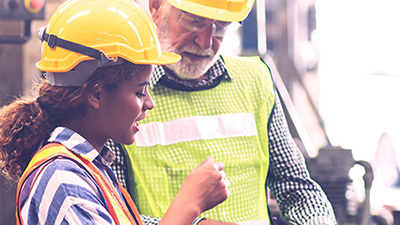 Two manufacturing employees discussing a problem